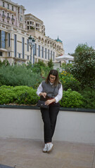 Wall Mural - Young woman exploring outdoors in monaco surrounded by luxury architecture and greenery on a pleasant day