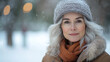 © Sadia - Winter portrait of a smiling woman with gray hair in a snowy park setting