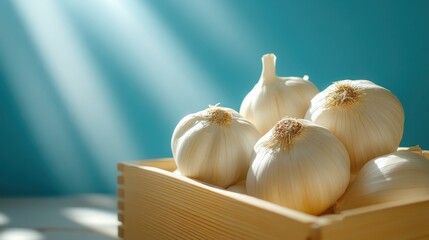 Wall Mural - a beautifully lit image showcasing fresh garlic bulbs in a wooden box, highlighting their organic sh