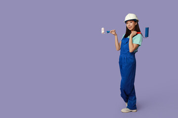 Wall Mural - female asian painter with rollers on purple background