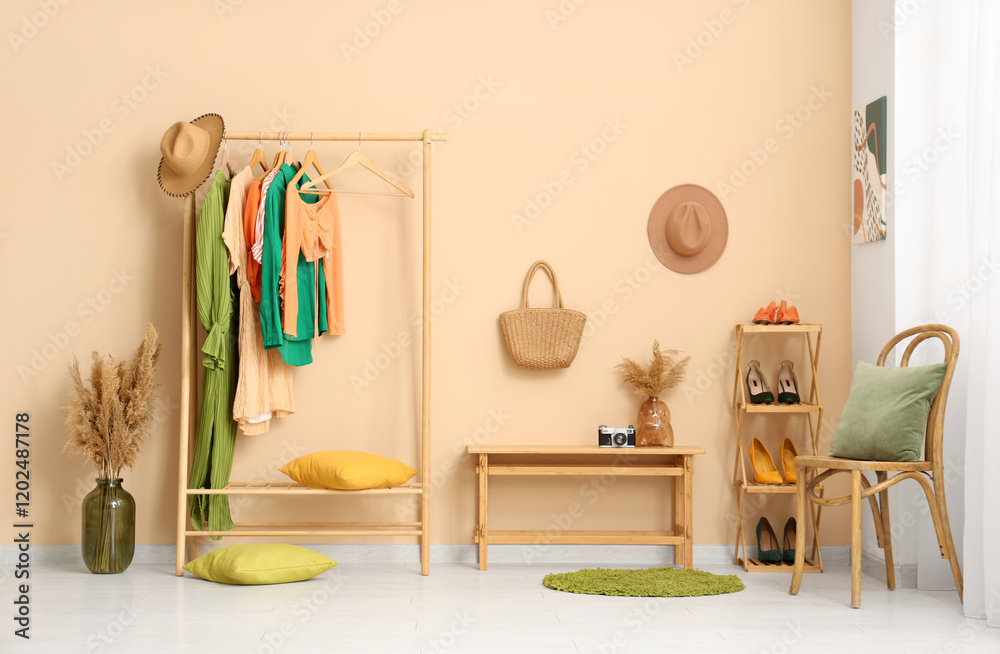 Interior of modern dressing room with rack and shelving unit