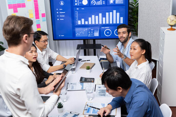 Fototapete - Analyst team utilizing BI Fintech to analyze financial data at table in meeting room. Businesspeople analyzing BI dashboard power for business insight and strategic marketing planning. Prudent