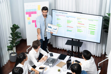 Leinwandbilder - Project manager communicate and collaborate with team using project management software display on monitor, tracking progress of project task and making schedule plan at meeting table. Prudent