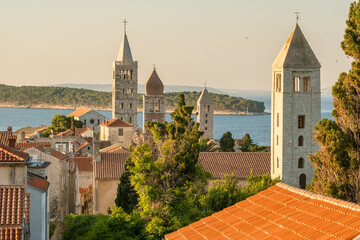 Wall Mural - HIstoric towers of a Rab town on Rab island at sunrise, Croatia.