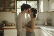 © InfiniteStudio - Young couple sharing a romantic kiss in a sunlit kitchen filled with greenery