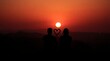 © It's Momi❤ - A romantic silhouette of a couple watching the sunset, surrounded by a warm orange glow, signifying love and connection.