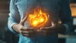 © stockagency - A person holding their stomach, with a fiery, glowing heart symbolizing passion or emotion.