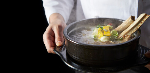 Wall Mural - Galbitang in the hands of a chef, traditional Korean food