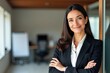 © SimpleDesignStudio - Confident Businesswoman Standing in Modern Office with Arms Crossed, Showcasing Professionalism and Elegance in a Corporate Environment