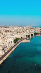 Wall Mural - Vertical video. Bari, Italy. The central embankment of the city during the day. Lungomare di Bari. Summer. Bari - a port city on the Adriatic coast, Aerial View. Rich colors