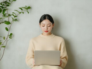 Poster - Minimalist Hybrid Workspace Young Asian Woman Engaged in Digital Collaboration with Laptop and Greenery – Modern Productivity Solutions for Creative Remote Work