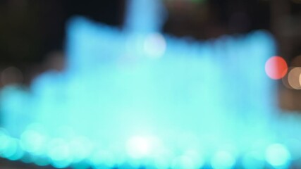 Wall Mural - a blue fountain with a blurry background. the image has a dreamy, ethereal quality to it