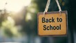 © Moon Guy - A wooden sign reading 'Back to School' hanging outdoors, symbolizing the return to education.