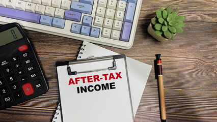 Wall Mural - Concept of After-Tax Income write on paperwork isolated on Wooden Table.