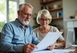 © StockHeroes - An old man and his wife are doing taxes at home using paperwork
