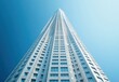 Skyscraper Reaching Towards Clear Blue Sky with Modern Architecture in Urban Setting Capturing Height and Innovation of Contemporary Design