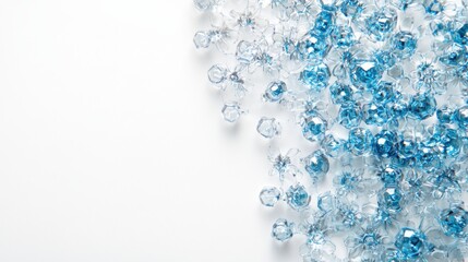 Poster - Close-up of sparkling blue and clear crystals scattered on a white surface, evoking elegance