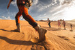 © cppzone - Big group of young tourists or hikers walks at sunset desert dunes. Gobi desert, Mongolia
