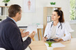 © Studio Romantic - Smiling female doctor or nurse is talking to a patient during a consultation in the hospital. The healthcare professional communicates effectively, offering medical care and support during the visit.