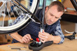 © auremar - a man working in a bicycle repair shop