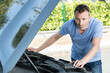 © auremar - man repairs under the hood of the car