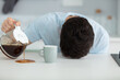 © auremar - sleepy man pouring coffee next to cup at home