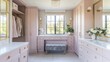 © somsri - A chic dressing room with blush pink cabinets, a soft gray bench, and gold accents.
