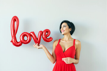 Wall Mural - Woman in red dress holding red 