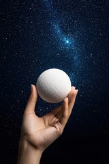 Wall Mural - Hand Holding a Sphere Against Starry Night Sky