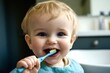 © Oleh - Adorable baby smiling and brushing teeth in bathroom