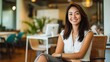 © Thavesak - Confident Thai-American Businesswoman Embracing Diversity in Dynamic Coworking Space with Relaxed Posture