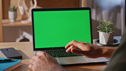 Wall Mural - Guy using touchpad chromakey laptop at desk closeup. Businessman surfing online
