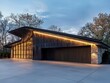 © Andrew - Modern Garage Design: A sleek, contemporary garage design featuring dark wood siding, large glass windows, and an illuminated curved roofline. The structure is beautifully lit at dusk.