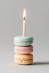 Wall Mural - Delicate macarons stacked with candle creating a festive atmosphere for a celebration cake alternative