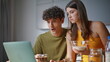 © stockbusters - Home couple having breakfast at kitchen closeup. Lovers enjoying show at laptop