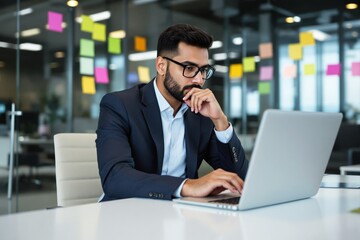 Aufkleber - Business professional working on a laptop in a modern office with colorful sticky notes on the glass walls in the background.