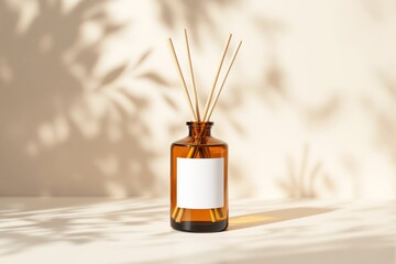 Aufkleber - Aromatic diffuser bottle with blank label and bamboo sticks on a light background with artistic shadows.