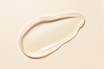 Poster - Closeup of light beige cosmetic liquid with droplets on pale background.