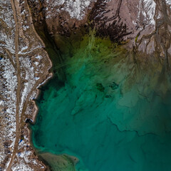lake from above, at the beginning of winter, clear water, blue lake bottom visible