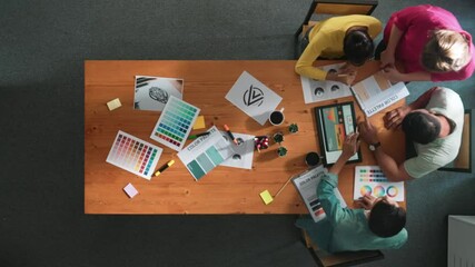 Poster - Top down aerial view of designer looking at tablet while project manager choosing color palettes. Top view of professional graphic designing and look at logo. Skilled team choosing graphic. Symposium.