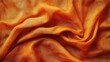 ©  AugmentArt - Orange textured fabric background with draped folds and gentle creases ideal for copy space applications