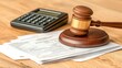 © weerasak - A wooden gavel rests on legal documents beside a calculator, symbolizing law, justice, and financial calculations in legal settings.