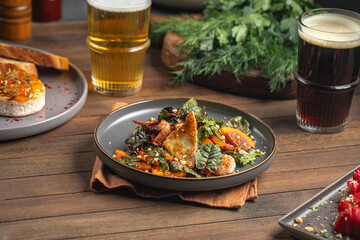 Wall Mural - Portion of salad with persimmons and shrimps on wooden served table