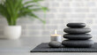 © SAN - Relaxing spa stones with candle tranquil setting still life indoor atmosphere calming ambiance