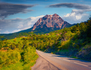 Wall Mural - empty asphalt road in outskirts of serre-poncon lake with huge peak on background, france, europe. a