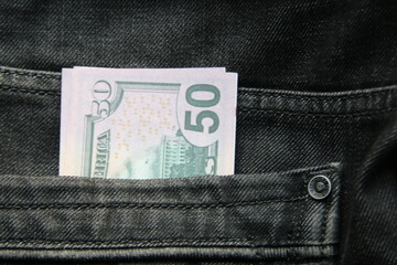 American dollars USD banknotes in jeans pocket.