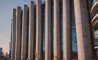 Poster - A tall building with many windows and a large tower. The building is made of concrete and has a modern design