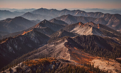 Poster - The mountains are covered in trees and the sky is a beautiful shade of orange. The scene is peaceful and serene, with the mountains providing a sense of calm and tranquility