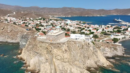 Wall Mural - Aerial drone cinematic video of picturesque and historic main village of Psara island featuring landmark church of Saint Nikolas, North Aegean islands, Greece