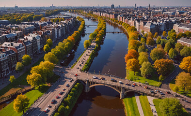 Aufkleber - A city with a river running through it and a bridge over the water. The bridge is surrounded by trees and buildings